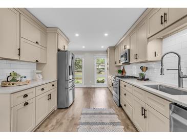 Modern kitchen features stainless steel appliances, white subway tile backsplash, and neutral-toned cabinets at 1541 Hutton Pl, Charleston, SC 29407