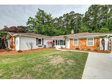 Charming single-story home with a manicured lawn, brick and wood exterior, and mature trees at 203 Red Fox Run, Summerville, SC 29485