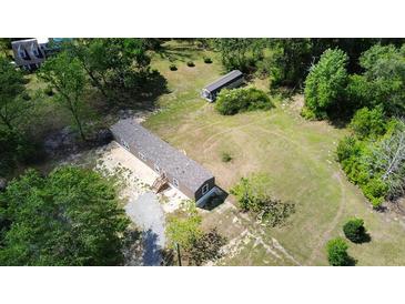 Aerial view of a mobile home on a spacious lot with a separate storage building at 226 Collier Ln, Moncks Corner, SC 29461
