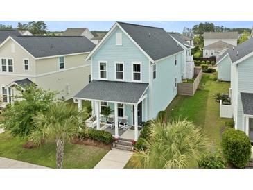 Charming two-story home with a covered front porch and nicely landscaped yard at 308 Watergrass St, Summerville, SC 29486