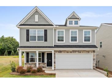 Charming two-story home with gray siding, stone accents, and a two-car garage at 333 O'Leary Circle, Summerville, SC 29483