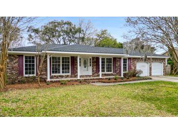 Charming single-story brick home with manicured lawn and attached two-car garage at 4343 Helene Dr, North Charleston, SC 29418