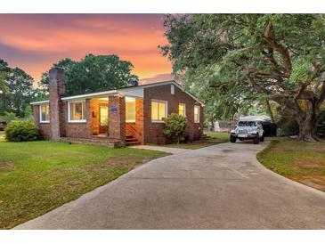 Charming brick home with a spacious driveway and mature trees at 757 Longfellow Rd, Charleston, SC 29407