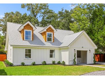 Charming exterior of a newly renovated home with dormer windows and fresh landscaping at 83 Avondale Ave, Charleston, SC 29407