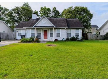 Charming single-story home with a red front door and a spacious lawn at 8508 Roanoke Dr, North Charleston, SC 29406