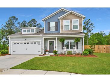 Charming two-story home with a well-manicured lawn and a welcoming front porch with rocking chairs at 107 Belgian Ct, Summerville, SC 29486