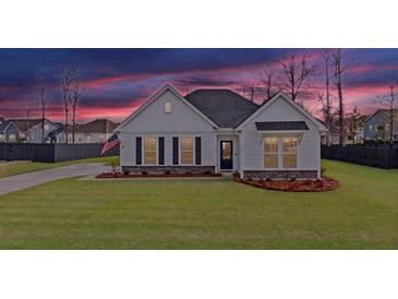 Charming single-Gathering home with a manicured lawn, classic white siding, and a welcoming front entrance at 179 Darby Meadow Ln, Ridgeville, SC 29472