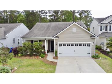 Charming single Gathering home featuring a two-car garage and well-maintained landscaping at 2022 Elvington Rd, Johns Island, SC 29455