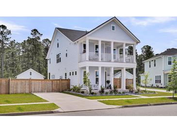 Charming two-story home featuring a double porch, meticulously landscaped yard, and a welcoming driveway at 435 Woodgate Way, Summerville, SC 29485