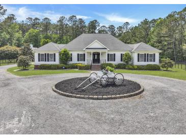 Beautiful single-story home with a circular driveway and manicured landscaping on a lush green lot at 1019 Spiers Cir, Bonneau, SC 29431