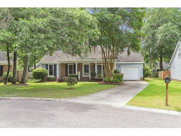 Charming single-story home featuring a well-manicured lawn, lush trees, and a welcoming facade at 106 Chaff Ct, Summerville, SC 29485