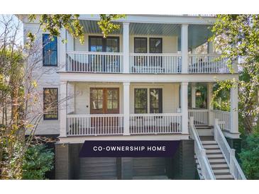 Beautiful home with a double front porch and garage space located beneath the house at 108 Carolina Blvd, Isle of Palms, SC 29451