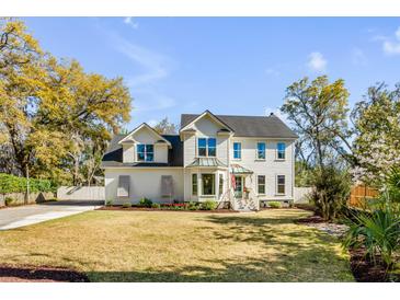 Charming two-story home featuring a well-manicured lawn, mature trees, and a classic American architectural style at 1081 Groves Manor Ct, Mount Pleasant, SC 29464