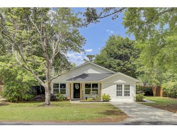 Charming single-story home with a welcoming front porch and well-manicured lawn at 115 Ridge Rd, Summerville, SC 29485