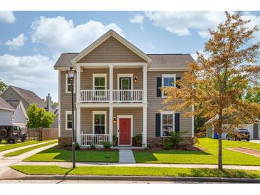 Charming two-story home with a welcoming front porch and well-manicured lawn in a suburban neighborhood at 1417 Roustabout Way, Charleston, SC 29414
