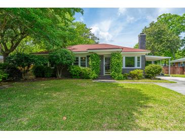 Charming brick home with a well-maintained lawn and mature trees, offering great curb appeal at 1707 Sharon Ave, Charleston, SC 29407