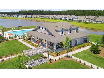 Beautiful clubhouse with outdoor pool overlooking community lake and manicured lawns at 247 Godwit Dr, Summerville, SC 29486