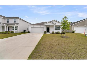 Charming single-story home featuring a well-manicured lawn and attached garage in a residential neighborhood at 292 Shadybrook Dr, Summerville, SC 29486