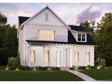 Charming two-story home with white siding, a welcoming front porch, and landscaped yard at 725 Rumbling Leaf Ln, Summerville, SC 29486
