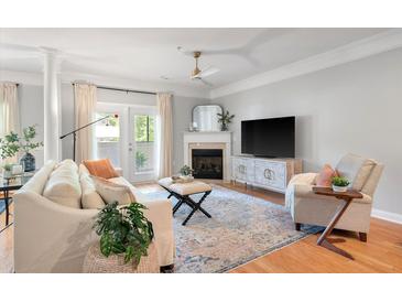 Cozy living room features a fireplace, hardwood floors, ceiling fan, and a seating area at 1025 Riverland Woods Pl # 106, Charleston, SC 29412