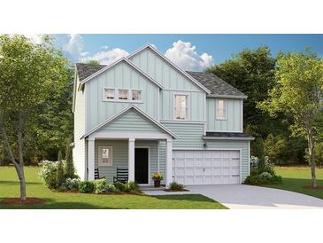 Charming two-story home with light green siding, covered porch, and attached garage at 111 Moscato Ln, Summerville, SC 29485