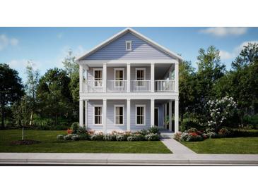 Charming two-story home featuring a double porch and manicured lawn at 122 Moscato Ln, Summerville, SC 29485