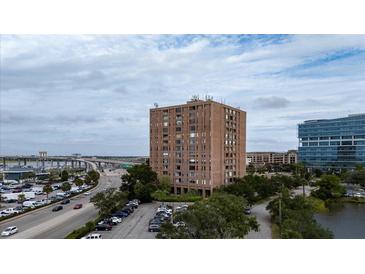 Exterior view of a multi-story apartment building with parking and greenery at 14 Lockwood Dr # 1-F, Charleston, SC 29401
