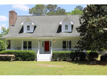 Charming two-story home with white siding, dormer windows and a welcoming front porch at 18808 Round O Rd, Round O, SC 29474
