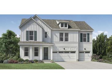 Beautiful two-story home featuring white siding, green shutters, a two car garage, and well-manicured landscaping at 2027 Riverbend Dr, Charleston, SC 29412