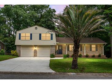 Charming two-story home with a well-manicured lawn, brick facade, and a two-car garage at 211 Bramblewood Dr, Summerville, SC 29485