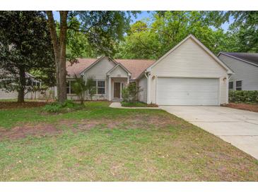 Charming single-story home with a two-car garage and landscaped front yard with mature trees and shrubs at 2154 Country Manor Dr Dr, Mount Pleasant, SC 29466