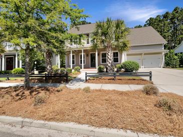 Charming two-story home with manicured landscaping, mature trees, and a two-car garage at 350 Oak Park St, Summerville, SC 29486