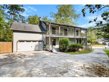 Two-story home with a two-car garage and charming double porches on a wide driveway at 1016 Cider Ct, Summerville, SC 29483