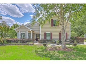 Charming home with manicured lawn, benches, and mature landscaping offering pleasant curb appeal at 105 Irish Oak Dr, Goose Creek, SC 29445