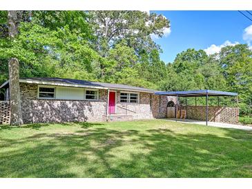 Charming brick home with a well-manicured lawn, covered carport, and lovely, mature trees in a desirable neighborhood at 108 Helen Dr, Summerville, SC 29483