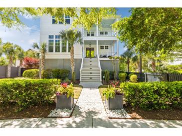 Charming two-story home with a beautiful landscaped front yard and inviting double porches at 1331 Smythe St, Daniel Island, SC 29492