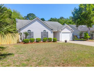 Charming one story home with manicured landscaping and a well-maintained lawn on a sunny day at 1918 Armory Dr, Mount Pleasant, SC 29466