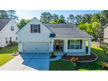 Charming home featuring a well-manicured lawn, attached garage, and inviting front porch at 2314 Hummingbird Ln, Summerville, SC 29483
