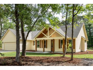 Charming home featuring a gabled roof and inviting front porch with beautiful wood accents at 2836 Edenborough Rd, Johns Island, SC 29455