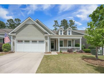 Charming single-story home with a manicured lawn, attached garage, and inviting front porch at 3006 Cross Vine Ln, Summerville, SC 29483