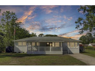 Charming single-story home with a welcoming front porch and well-maintained lawn at 32 Elmora Ave, Goose Creek, SC 29445