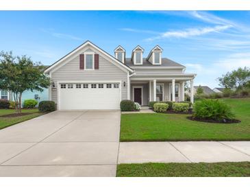 Charming single-Gathering home featuring a well-manicured lawn and a two-car garage with traditional architectural details at 403 Hidden Meadow Ln, Summerville, SC 29486