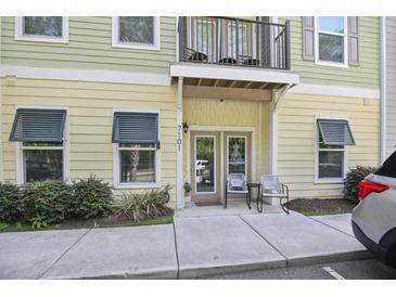 Inviting condo entrance featuring a balcony, double glass doors and chairs on the front porch at 7101 Bowen Corner Ave, Hanahan, SC 29410