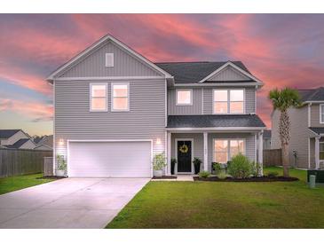Charming two-story home with a well-manicured lawn and integrated two car garage at 102 Bolsena Ct, Summerville, SC 29486