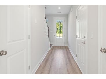 Bright foyer features wood-look flooring, neutral paint, and natural light from the front door at 102 Hawthorne Landing Dr, Goose Creek, SC 29445