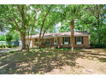 Charming brick home featuring mature trees, a well-manicured lawn, and a classic design at 106 Kent Cir, Ladson, SC 29456
