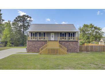 Charming home with a brick foundation, a metal roof, and a welcoming wooden staircase leading to the entrance at 108 Mourning Dove Dr, Bonneau, SC 29431