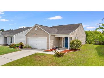 Charming tan home featuring a blue front door, well-manicured lawn, and attached garage at 151 Tyger St, Summerville, SC 29485