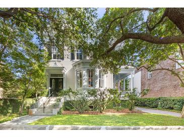 Charming home with beautiful curb appeal, featuring mature trees, lush landscaping, and a classic facade at 155 Wentworth St # A, Charleston, SC 29401