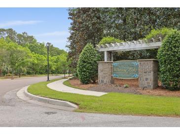 Welcoming Whitney Lake community entrance sign with mature landscaping and well-maintained street at 1825 Brittlebush Ln, Johns Island, SC 29455